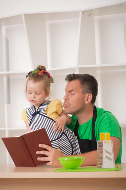 Family concept, cute little girl with father preparing to cook - Foto, Imagem