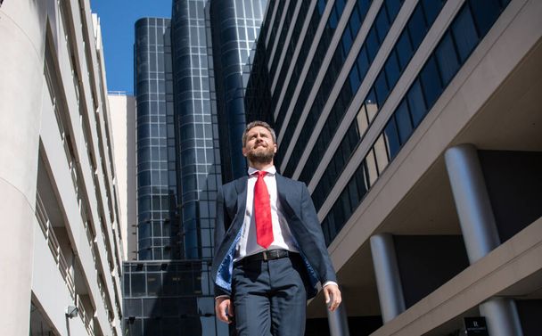 Portrait of a confident mature businessman standing outside office. - Photo, image