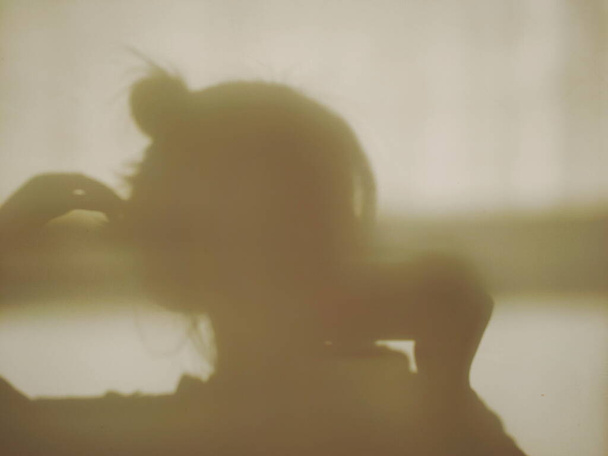 silhouette of a young woman with a blurred background - Photo, Image
