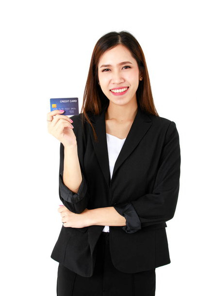 Asian young long brown hair successful beautiful businesswoman wears black formal suit with pants and white inner shirt stand smile cross arm hold and show blue credit in hand in white background. - Photo, Image