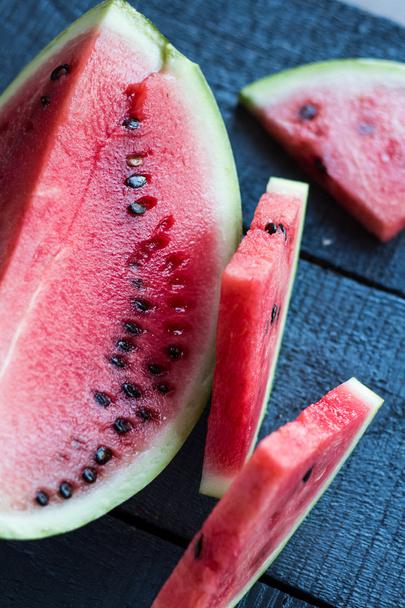 Juicy, sweet slices of watermelon  on a dark wooden - Фото, зображення