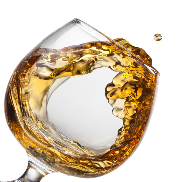 Splash of cognac in glass isolated - Photo, Image