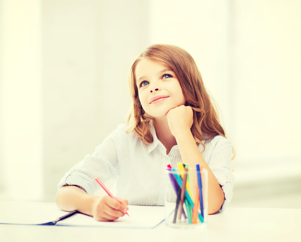 little student girl drawing at school - Foto, imagen