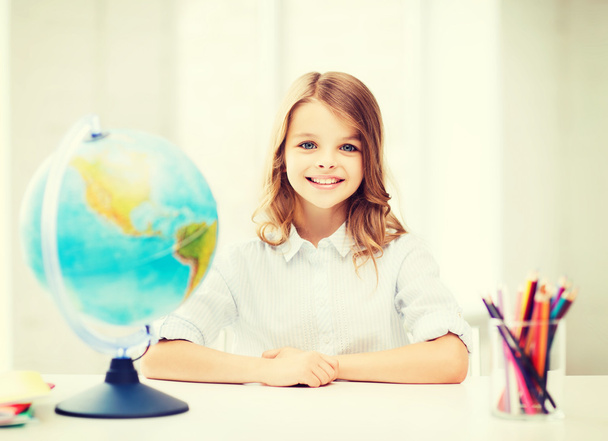 student girl with globe at school - Foto, Imagen