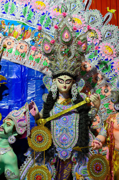 Piękna twarz bogini Saraswati idol, Durga Puja festiwal w nocy. Strzelanina pod kolorowym światłem w Howrah, West Bengal, Indie. - Zdjęcie, obraz