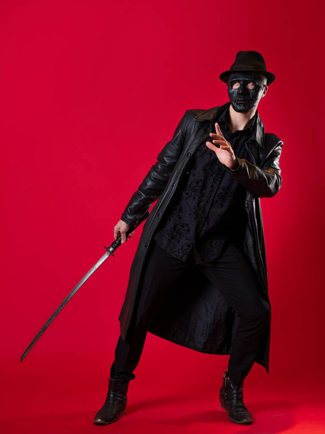 A mysterious ninja assassin in a noir style. A man in black leather clothes - Foto, afbeelding