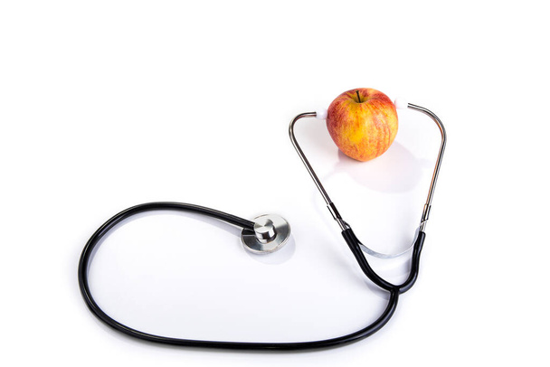 Стетоскоп на яблуці. Концепція здорової їжі та способу життя
 - Фото, зображення