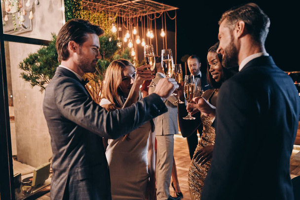 Group of people in formalwear communicating and smiling while spending time on luxury party - Foto, Imagem