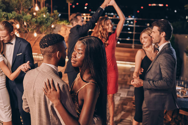 Beautiful young people dancing and smiling while spending time on luxury party - Photo, Image