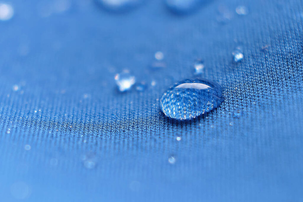 water beading on fabric. Waterproof coating background with water drops - Photo, Image