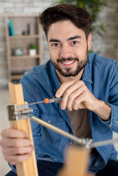 happy man and do it yourself furniture assembly - Fotoğraf, Görsel