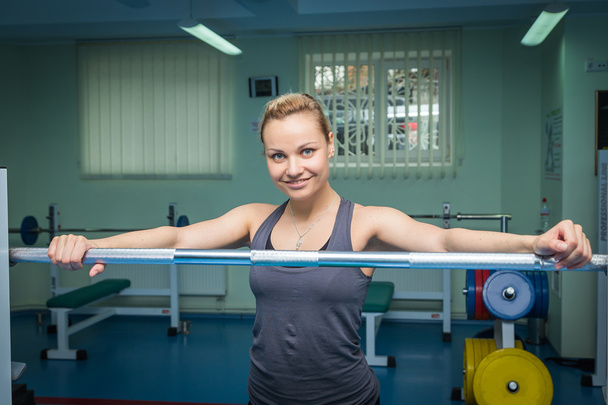 Woman with barbell - Фото, изображение
