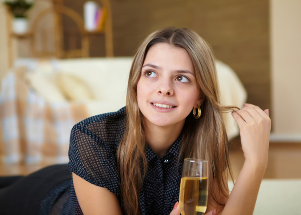 Young girl drinking champagne at home - Фото, зображення