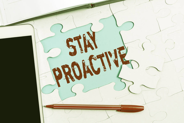 Text caption presenting Stay Proactive. Business idea Taking own decision to go ahead of anticipated events Building An Unfinished White Jigsaw Pattern Puzzle With Missing Last Piece - Photo, Image