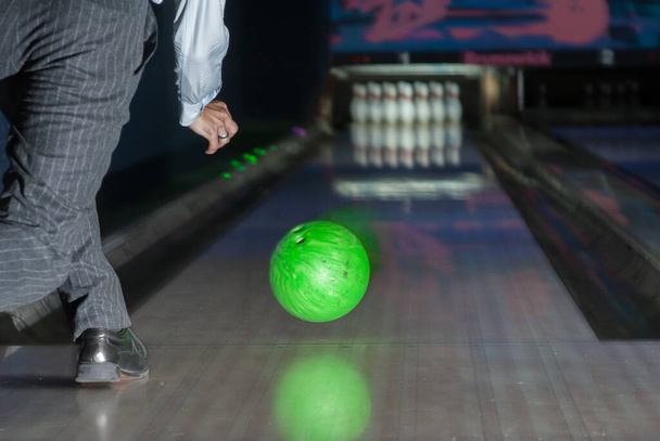 Person throwing a green bowling ball. - Photo, Image