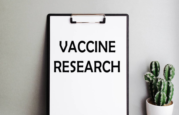 VACCINE RESEARCH inscription on clipboard with holder. Health care concept. - Zdjęcie, obraz