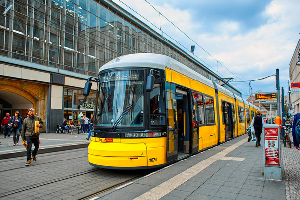 Modern yellow city tram at a public transport stop. Berlin, Germany - 05.17.2019 - 写真・画像