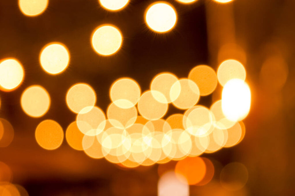 blurred yellow lights at night holiday background - Photo, Image