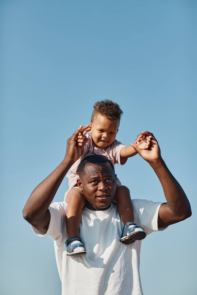 Father Carrying Son on Shoulders - Photo, Image