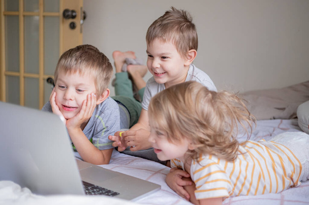 Little kids having video chat via laptop at home lifestyle - Valokuva, kuva