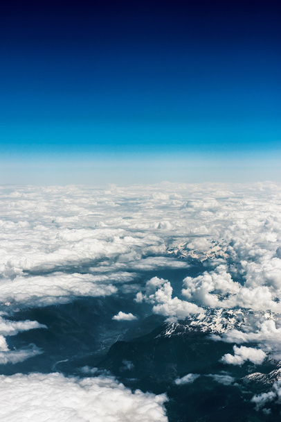 Above aerial plane view of Italian alps and cloudscape - Zdjęcie, obraz