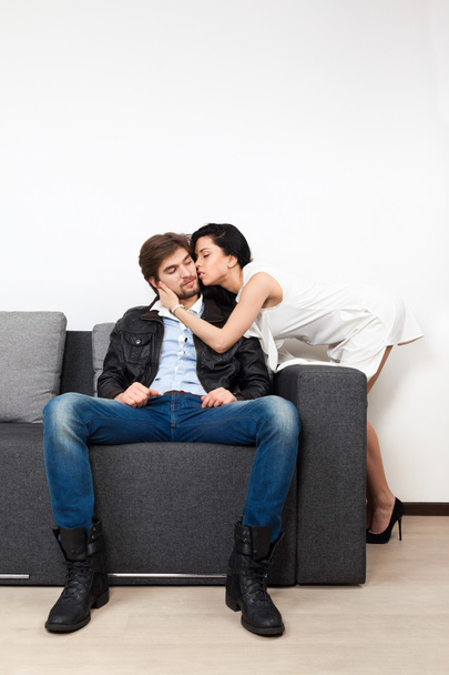 Couple flirting on couch - Фото, зображення
