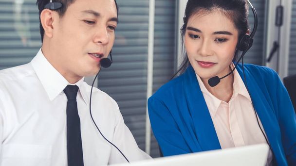 Business people wearing headset working actively in office - Photo, Image