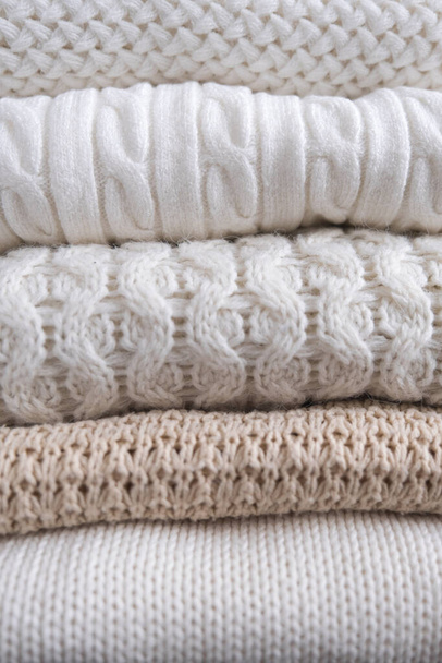 Warm cozy clothes with different knitted patterns close-up. Autumn or winter background. - Photo, Image