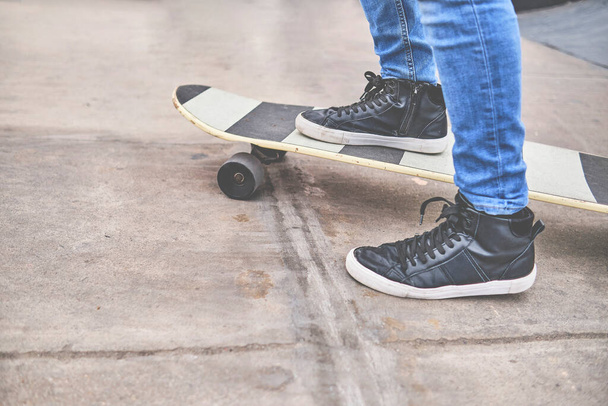 Young skateboarding on the streets, close up on shoes, transportation in the new normal - Fotografie, Obrázek