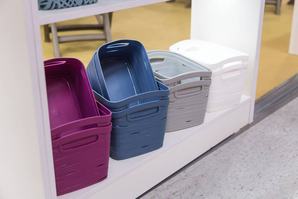 Organization of home space and comfort, plastic boxes containers baskets for wardrobe closets on the shelf, household goods for storing things - Valokuva, kuva