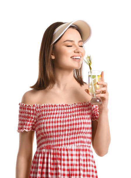 Beautiful young woman drinking fresh lemonade on white background - Photo, image