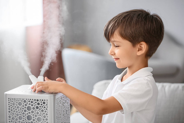 Little boy with modern humidifier at home - Foto, imagen