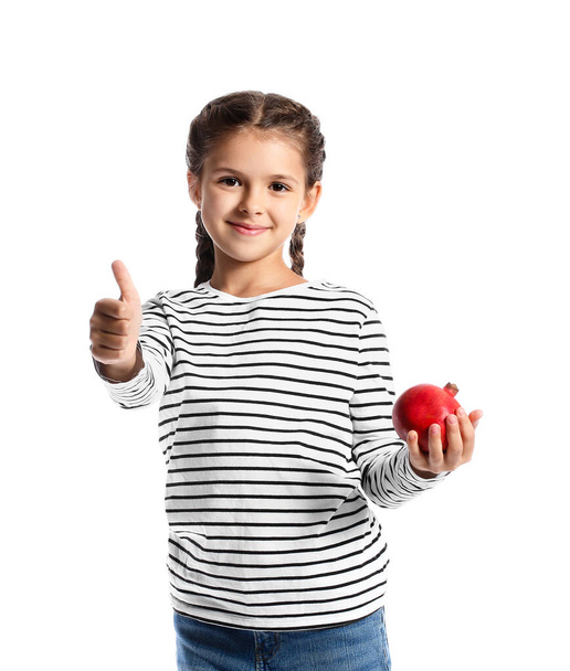 Little girl with pomegranate showing thumb-up on white background - 写真・画像