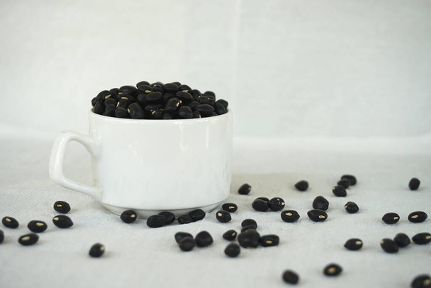 Black beans with porcelain cups - Фото, зображення