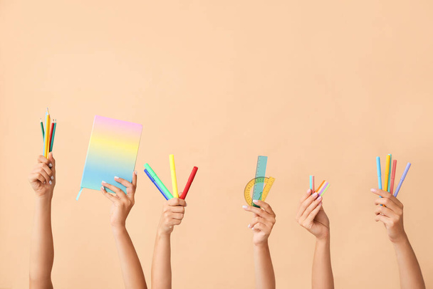 Many different hands with school supplies on color background - Foto, Bild