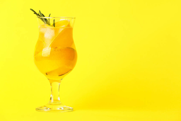 Glass of cold melon cocktail on yellow background - Foto, imagen