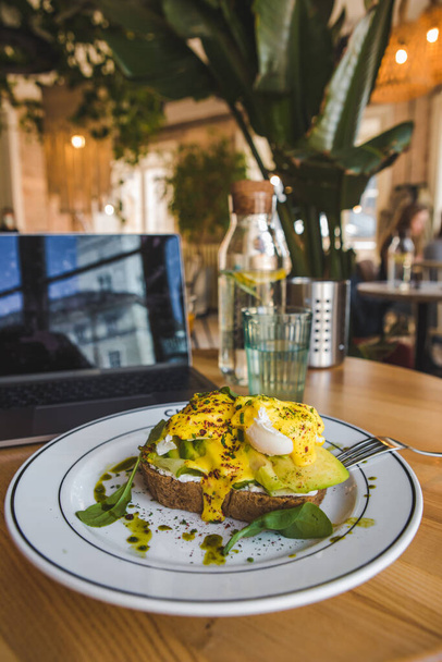 pain grillé à l'avocat et les œufs sur l'assiette dans le restaurant brun couleurs espace de copie - Photo, image