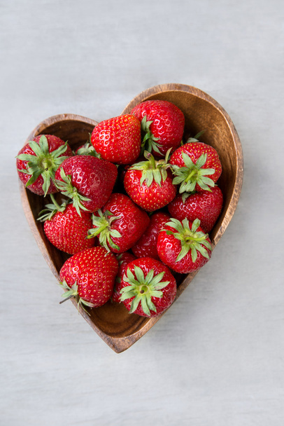 Close-up of fresh strawberries in heart shape plate - Фото, изображение
