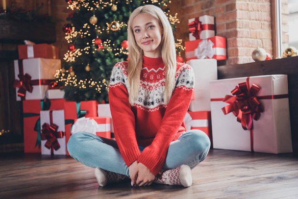 Portrait of attractive cheerful girl sitting on floor resting festal day december winter at modern brick loft industrial style indoors - Photo, Image
