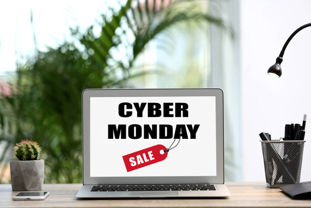 Modern laptop with text Cyber Monday Sale on screen in room  - Foto, Bild