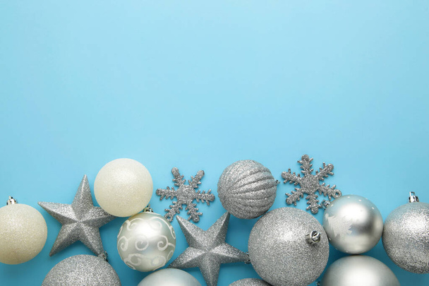 Christmas silver baubles on blue background with copy space. New Year composition - Foto, afbeelding