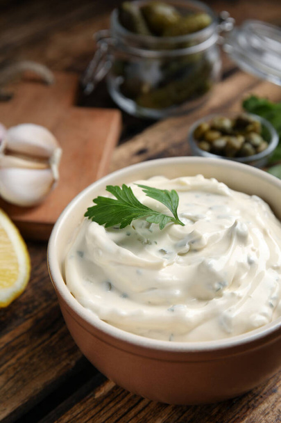 Tasty tartar sauce and ingredients on table, closeup - Photo, image