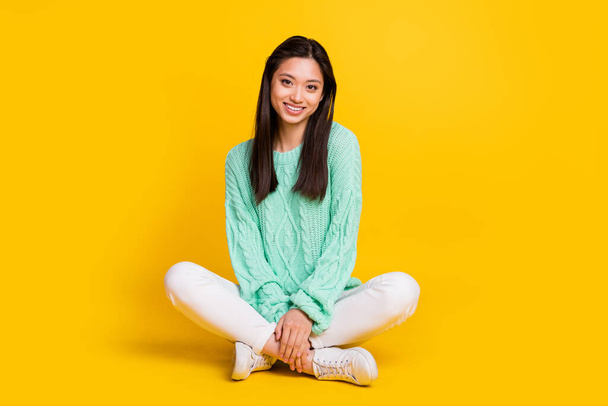 Full body photo of pretty cute nice woman sit floor good mood smile isolated on shine yellow color background - Photo, image
