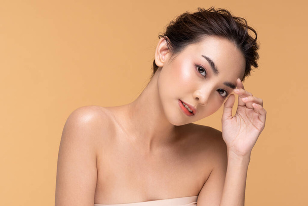 Beautiful Asian woman touching eyebrow smile with clean and fresh skin Happiness and cheerful with positive emotional,isolated on Beige background,Beauty Cosmetics and spa Facial treatment Concept - Valokuva, kuva