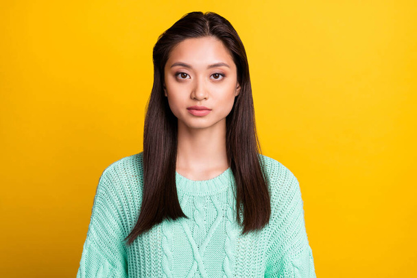 Photo of serious confident young woman dressed teal pullover isolated yellow color background - Photo, Image