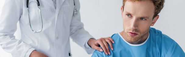doctor in white coat calming sick and upset patient in hospital, banner - Фото, изображение