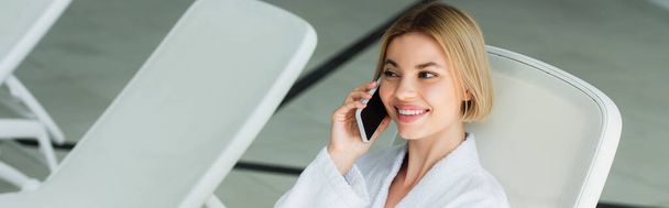 Smiling woman talking on mobile phone in spa center, banner  - Foto, immagini