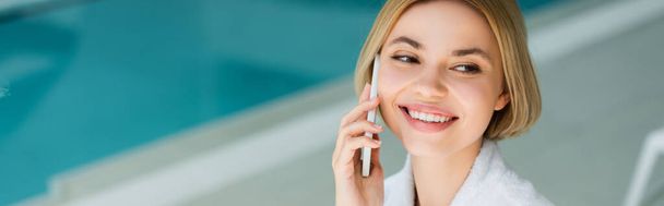 Positive woman talking on mobile phone in spa center, banner  - Photo, Image