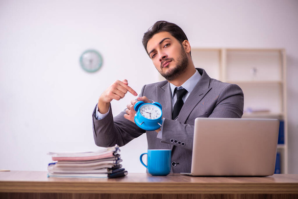 Young businessman employee in time management concept - Photo, Image