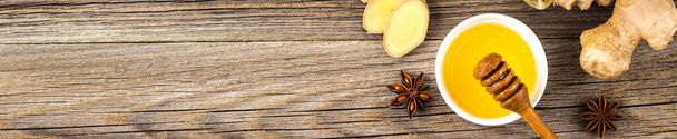 banner of Autumn hot drink tea with ginger, lemon, honey and spices on wooden background. Copy space - Zdjęcie, obraz